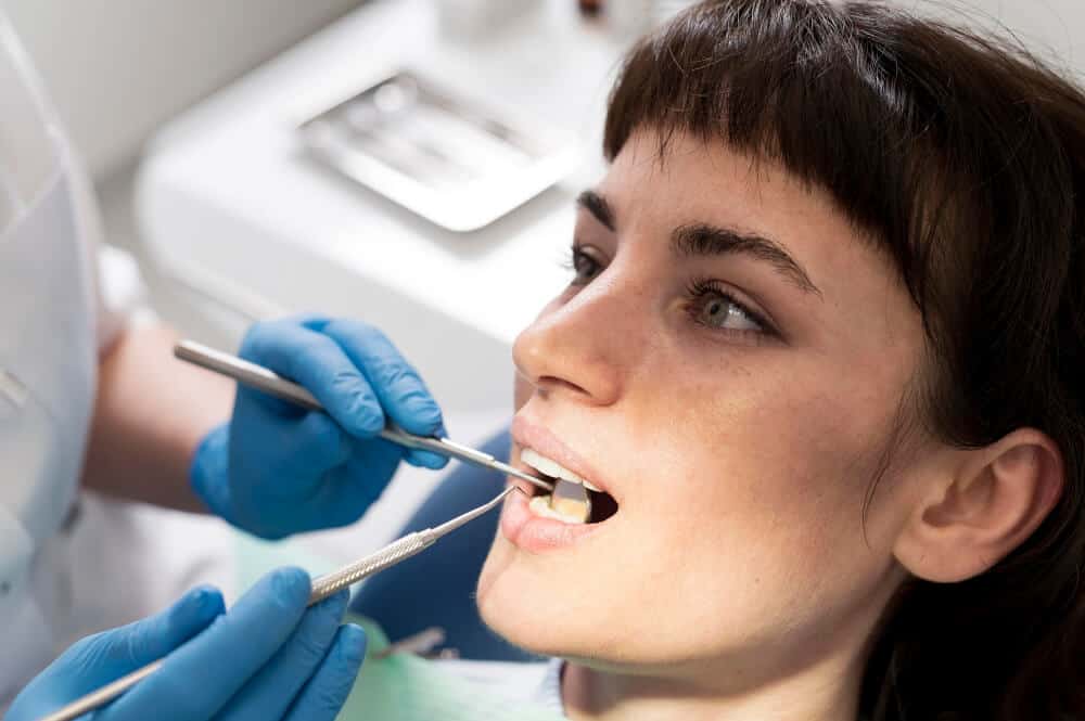 Cheltenham dentist examining a tooth to assess whether root canal treatment or extraction is appropriate