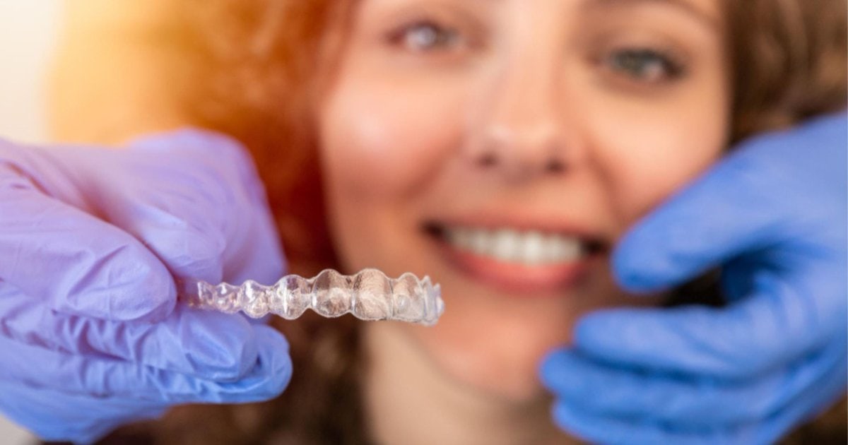 Patient with Invisalign clear aligner in Cheltenham